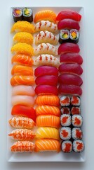 Assorted sushi elegantly arranged on white platter