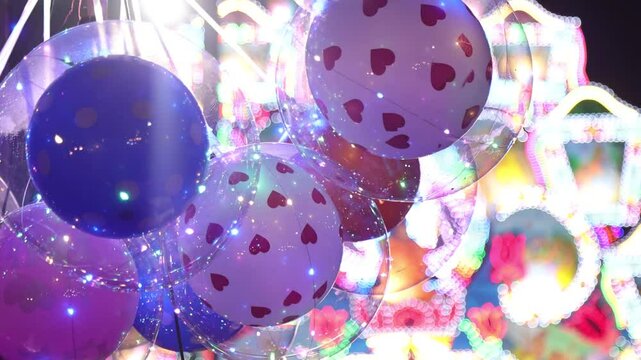 Glowing BOBO Balloon with Inner Balloon and LED Lights at Night During Vesak in Sri Lanka &ndash; Cinematic Pan with Blurred Thorana in Background