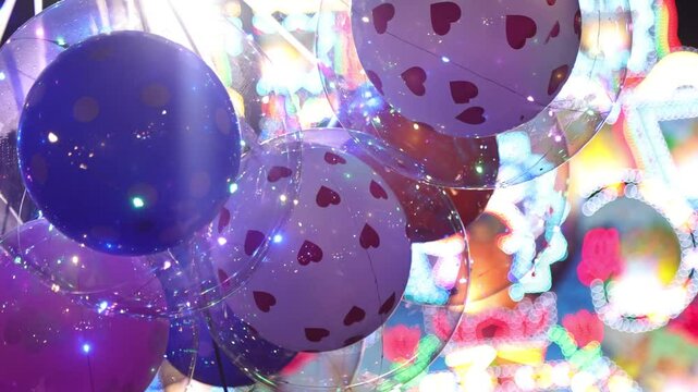 Glowing BOBO Balloon with Inner Balloon and LED Lights at Night During Vesak in Sri Lanka &ndash; Cinematic Pan with Blurred Thorana in Background