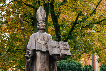 Saint Paulinus of Trier – a bronze statue near the Basilica of St Paulinus in Trier, Germany. "Jesus = Gott + Mensch" [Jesus = God + Man].