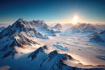 Snowy mountain range at sunrise. Vast, icy landscape under a brilliant sun