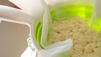 Cheese making draining cloth liquid curds close up