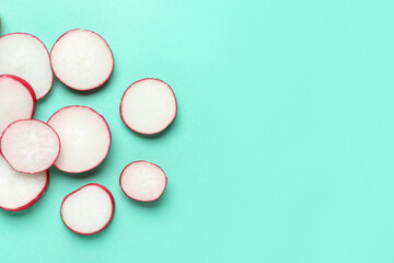 Slices of fresh radish on blue background
