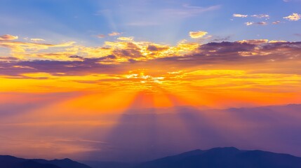 Fototapeta premium Spectacular sunset over mountains with lightrays