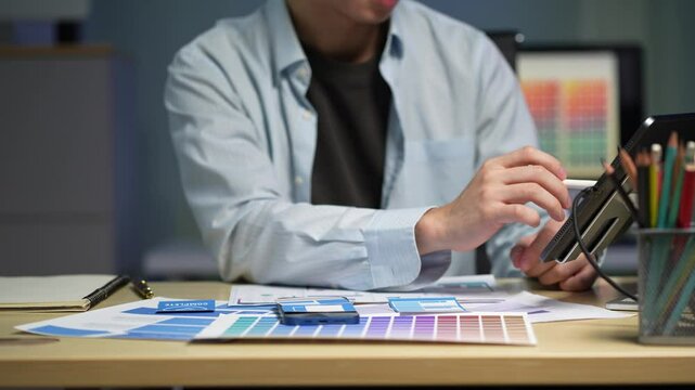 Male coder or developer working overtime using a computer display in problem solving at workplace.