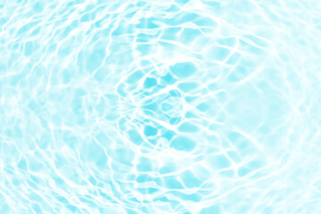 Blue water with ripples on the surface. Defocus blurred transparent blue colored clear calm water surface texture with splashes and bubbles. Water waves with shining pattern texture background.
