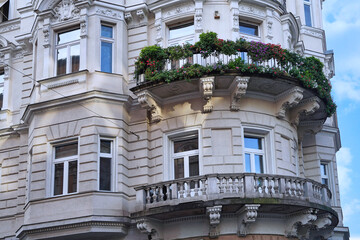 Facade of old European baroque style apartment building with curved balcony