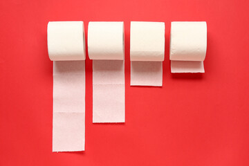 Rolls of toilet paper on red background
