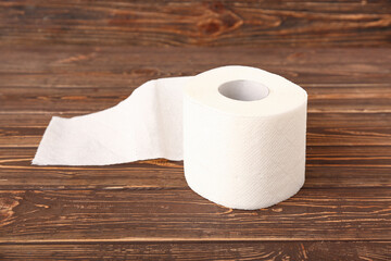Roll of toilet paper on wooden background