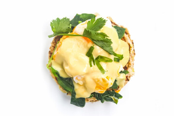 eggs benedict with toast and spinach isolated on white background
