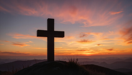 Cross silhouette against sunset sky