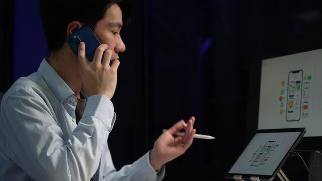 Male coder or developer working overtime using a computer display in problem solving at workplace.