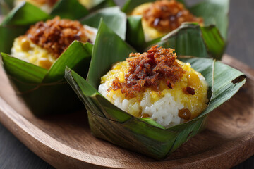 Delicious sticky rice with coconut milk and yellow beans served in banana leaves