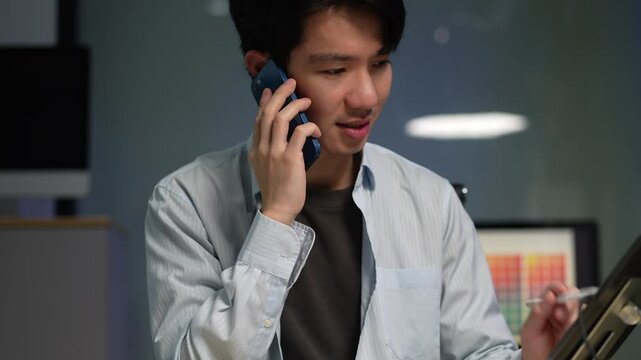 Male coder or developer working overtime using a computer display in problem solving at workplace.