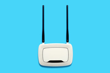 Modern wi-fi router on blue background