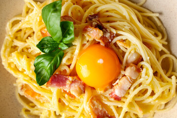 Tasty pasta carbonara on plate as background, closeup