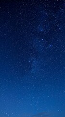 Obraz premium A breathtaking view of a clear dark blue night sky dotted with countless shimmering stars above.