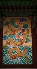 Fototapeta premium Magnificent Asian Dragon Mural Painting on Temple Wall, Intricate Details and Vivid Colors