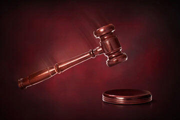 Judge gavel on dark red background