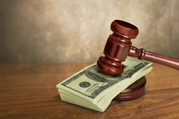 Judge gavel with money on wooden table