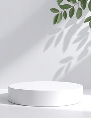 A pristine white round table adorned with vibrant green leaves, creating a fresh and inviting atmosphere, perfect for a cozy indoor setting.