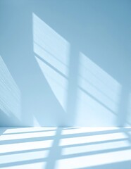 Obraz premium A bright white wall illuminated by soft, natural light streaming through a nearby window, casting gentle shadows and creating a serene atmosphere.