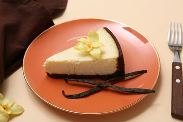 Plate with piece of sweet vanilla cheesecake on beige background