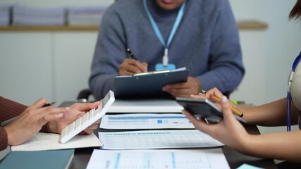 Teamwork process, Business team using a calculator to calculate the numbers of statistic business profits growth rate on documents graph data, desk in the office. - Powered by Adobe