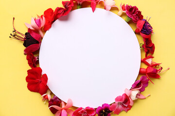 Blank card with different beautiful edible flowers on yellow background