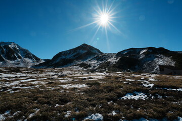 Bright Sunstar Over the Snowy Alpine Landscape of Tateyama, Japan