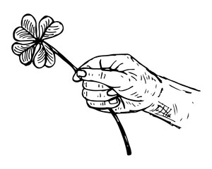 Hand holding a lucky four-leaf clover, representing fortune, hope, and wishes.