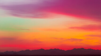 Fototapeta premium Colorful sunset casts vibrant hues on skyline