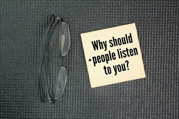 Glasses and wood with the question word Why should people listen to you?