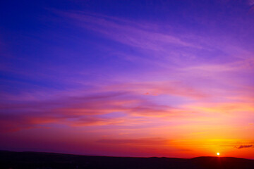 Spectacular Sunset Over a Landscape of Blues and Oranges. Sunset over the horizon with vibrant colors