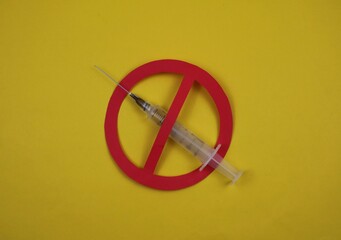 Red Warning Symbol Over Syringe on yellow Background