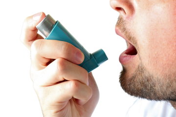 Man using inhaler for asthma relief indoors, isolated on white, PNG