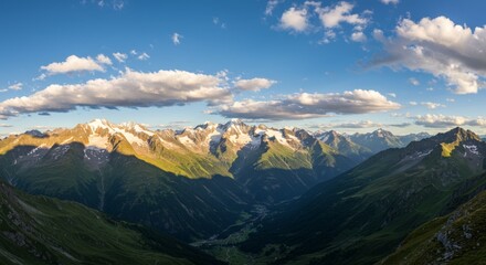 Alpine peaks and valleys at sunset. Lush greenery, snow-capped mountains, and a vast landscape