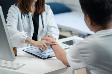 Fototapeta premium Close up of medical worker putting his fingers on a wrist of a male patient while checking her pulse during an appointment.Taking care of health.