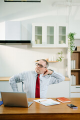 Overworked businessman office worker suffering from neck pain after had a long day at desk. office syndrome concept
