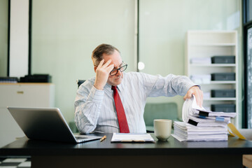 Professional businessman working at office with laptop, tablet, and notes. Perfect for business, finance