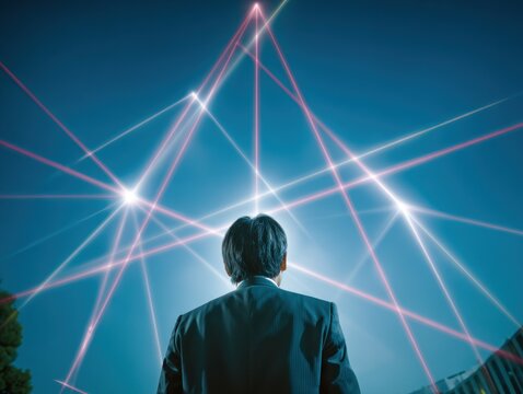 Businessman gazing at network of light rays - Powered by Adobe