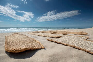 Beach with woven straw mats on the sand, creating the perfect setting for sunbathing and relaxation.