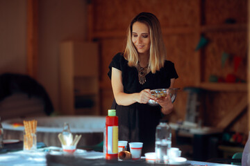 Woman Sets the Table for a Family Party at Home. Happy mom preparing a home party for her kids 