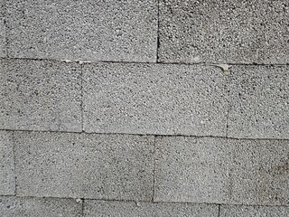 Textured concrete blocks create interesting pattern on a wall under natural light in a construction...