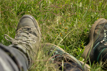 Man and woman resting on the mountain after hiking in the mountains