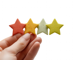 Four Colorful Star-Shaped Cookies in Hand A Symbol of Rating and Feedback