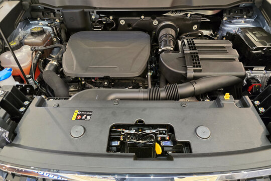 Penang, Malaysia &ndash; May 24, 2025: Close-up view of the hybrid engine bay of a Haval H6 HEV, showcasing the components, hoses, and plastic engine cover under showroom lighting.