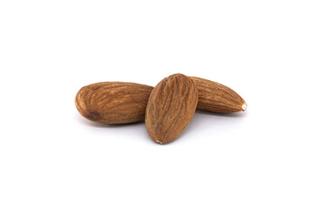 Three delicious almonds rest against a plain white background, ready for eating or cooking.