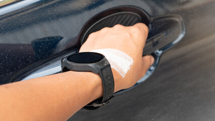Driver arm has a wound covered with tape on the back of his hand. He wears an old dusty watch. Hold the car door handle to open it.