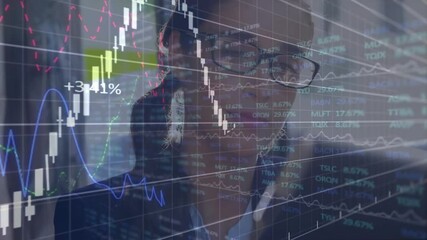 Woman executive glancing at tablet while tracking animated candlestick charts for market insights - Powered by Adobe